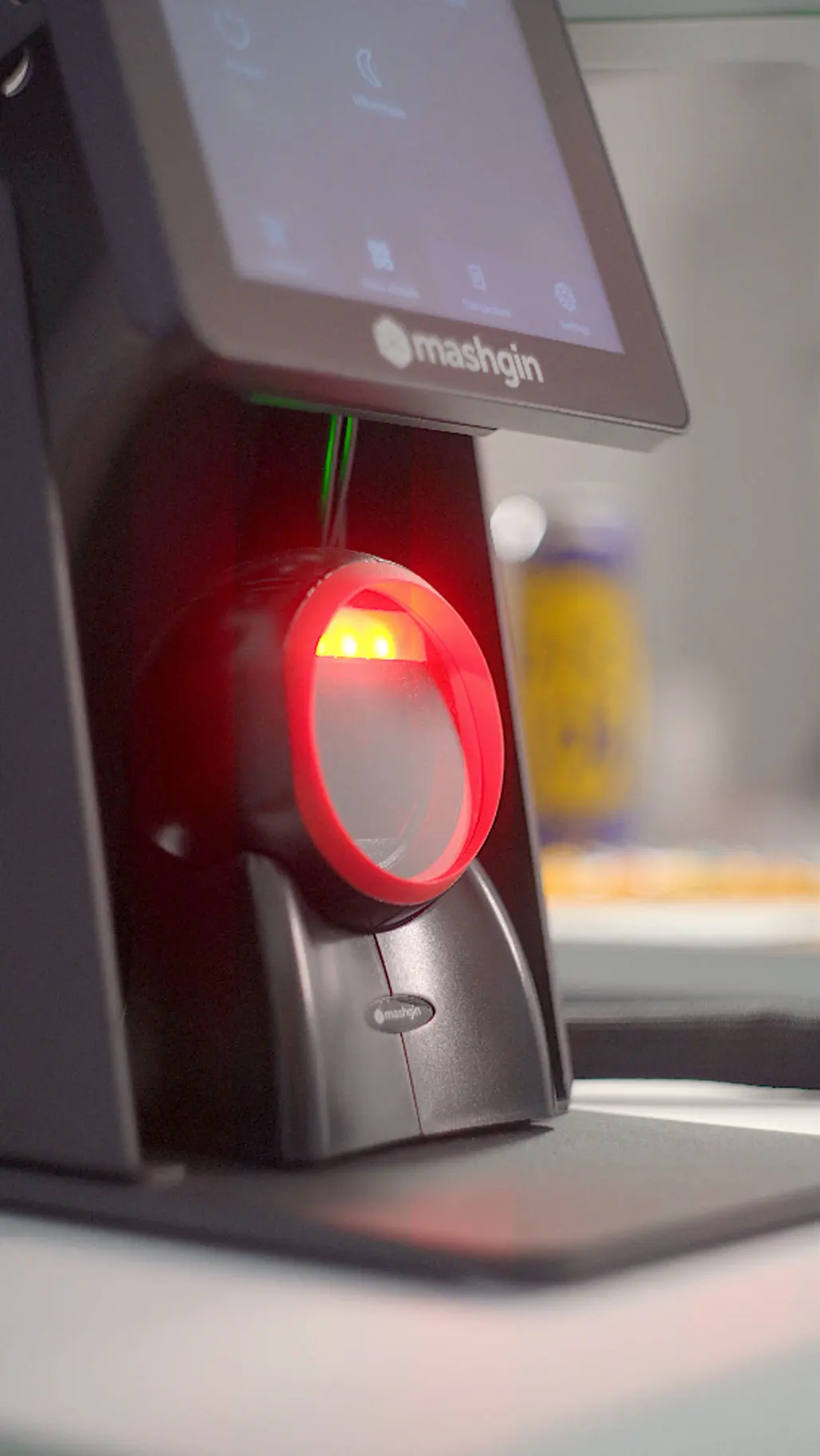 A Mashgin's rear-facing CSR scanner glows red.